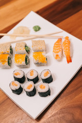 Sushi plate / menu include California Roll, Caterpillar Roll, Sake Roll and Ebi Nigiri. Flat lay photo of Sus
