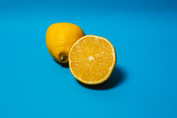 Lemon cut in half, isolated on blue background.