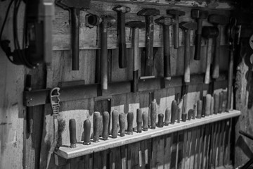 Old tools - hammers and files of different sizes, black and white photo.