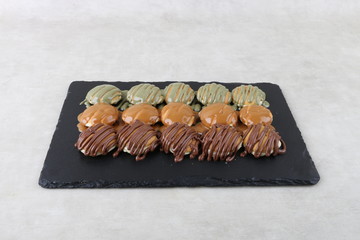 small pancake with chocolate and pistachio - top view on a texture background 