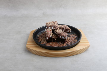 volcano cake on wooden plate on texture background 