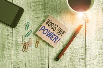 Conceptual hand writing showing Words Have Power. Concept meaning as they has ability to help heal hurt or harm someone Stationary placed next to a coffee cup above wooden table