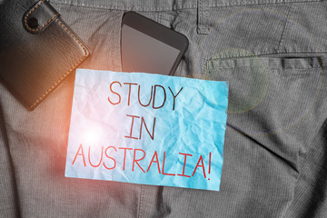 Text sign showing Study In Australia. Business photo text going into foreign country order complete your studies Smartphone device inside trousers front pocket with wallet and note paper