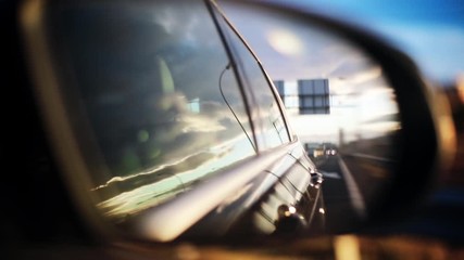 Close up footage of a car rear view mirror, at dusk.