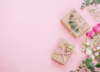Craft paper wrapping gift boxes on pink background