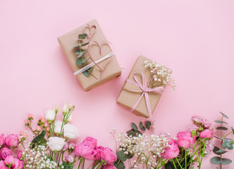 Craft paper wrapping gift boxes on pink background
