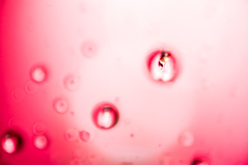 Water droplets on pink and white background