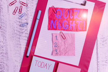 Text sign showing Quiz Night. Business photo text evening test knowledge competition between individuals Clipboard sheet crushed sticky note clip notepads marker wooden background