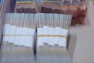 Carton boxes filled with sorted money and stored in a cage in the treasury department.