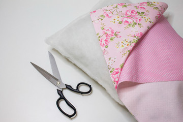 Materials and accessories for handmade. The process of hand sewing with fabric, scissors, accessories for sewing. Sewing pillows