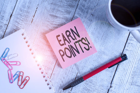 Writing note showing Earn Points. Business concept for collecting scores in order qualify to win big prize Stationary placed next to a cup of black coffee above the wooden table