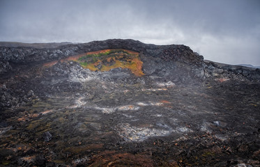 Leirhnjukur old black lava field and smoke in Iceland, overcast. Cloudy day in September 2019
