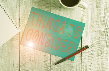 Text sign showing Things To Consider. Business photo text think about something carefully in order to make decision Stationary placed next to a cup of black coffee above the wooden table
