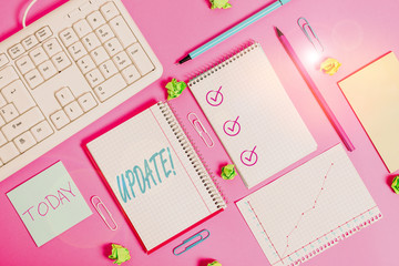 Writing note showing Update. Business concept for make something more modern or up to date like software program Writing equipments and computer stuffs placed above colored plain table