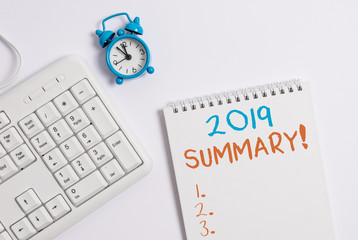 Writing note showing 2019 Summary. Business concept for summarizing past year events main actions or good shows Keyboard with empty note paper and pencil white background