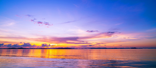 Beautiful light sunset or sunrise over sea scenery nature background with reflex in the water surface.