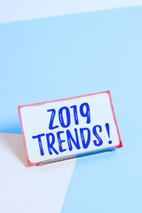 Text sign showing 2019 Trends. Business photo showcasing general direction in which something is developing or changing Paper placed tilted above buffer wire on soft pastel multi colours backdrop