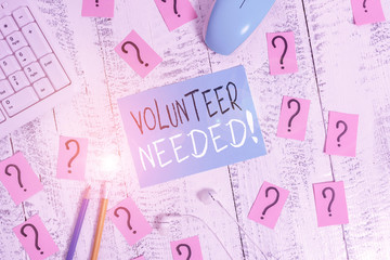 Text sign showing Volunteer Needed. Business photo text asking demonstrating to work for organization without being paid Writing tools, computer stuff and scribbled paper on top of wooden table