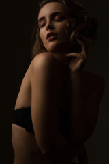 Pretty girl wears lingerie posing with closed eyes