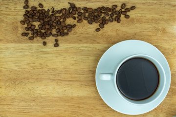 cup of coffee on table with beans