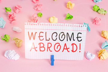 Writing note showing Welcome Abroad. Business concept for something that you say when someone gets on ship Colored crumpled papers empty reminder pink floor background clothespin