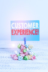 Writing note showing Customer Experience. Business concept for product of interaction between organization and buyer Reminder pile colored crumpled paper clothespin wooden space