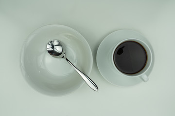 White dishes, silver cutlery and coffee