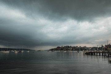 Obraz premium stormy clouds over bay at dawn