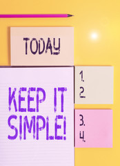 Handwriting text Keep It Simple. Conceptual photo ask something easy understand not go into too much detail Colored empty papers with copy space on the yellow background table