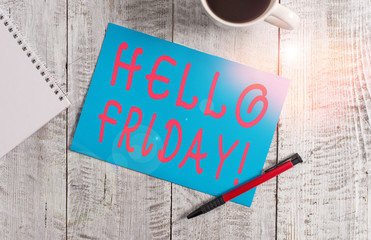 Text sign showing Hello Friday. Business photo text used to express happiness from beginning of fresh week Stationary placed next to a cup of black coffee above the wooden table