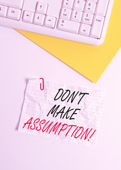 Text sign showing Don T Make Assumption. Business photo showcasing something that you assume to be case even without proof Flat lay above white blank paper with copy space for text messages