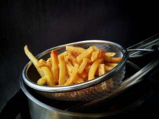 French fries made at home, French fries in the oil filter sieve.