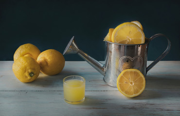 Still life of lemons with lemon juice