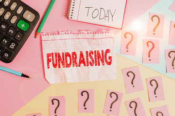 Conceptual hand writing showing Fundraising. Concept meaning seeking to generate financial support for charity or cause Mathematics stuff and writing equipment on pastel background