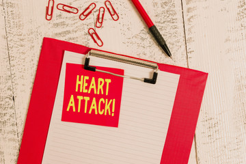 Word writing text Heart Attack. Business photo showcasing sudden occurrence of coronary thrombosis resulting in death Clipboard paper sheet sticky note ballpoint clips vintage wooden background
