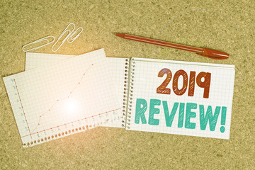 Writing note showing 2019 Review. Business concept for remembering past year events main actions or...