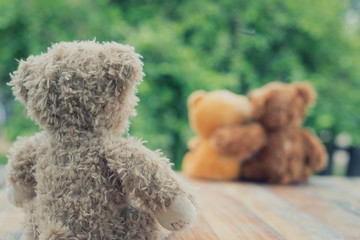 Brown teddy bear cute disappointed in love because they embraced each other on nature background with sweet and romantic moment.