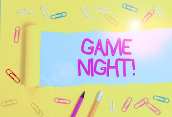 Text sign showing Game Night. Business photo showcasing usually its called on adult play dates like poker with friends Stationary and torn cardboard placed above a plain pastel table backdrop