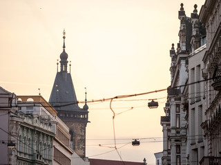 Obraz premium Picture of the iconic belfry tower of the New Town Hall (novomestska radnice) of Prague, Czech Republic, surrounded by narrow touristic medieval streets and houses.