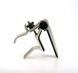 Capo clip for guitar strings isolate