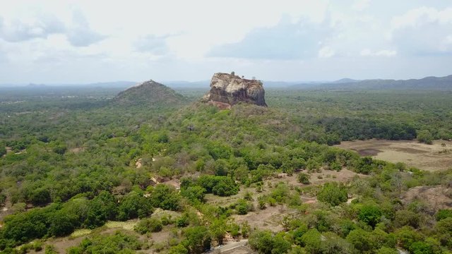Aerial view of Sigiriya or Lion Rock, Ancient Fortress and UNESCO World Heritage Site in Sigiriya, Sri Lanka. Travel destination of South Asia. 4K Drone Video.