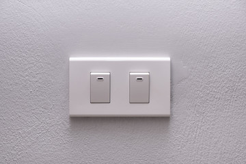 Electricity switch or lamp switch on white wall