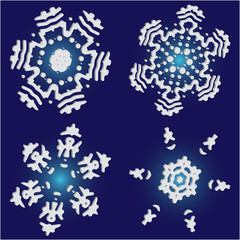 Set of isolated falling snowflakes on blue background.