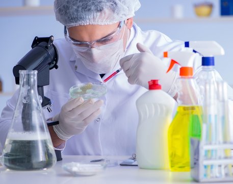 Man in the lab testing new cleaning solution detergent