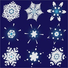 Set of isolated falling snowflakes on blue background.