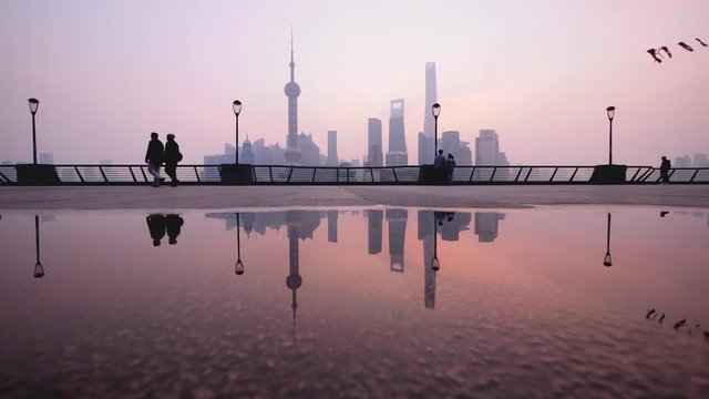 silhouette of people flying kite at The Bund in Shanghai in the morning, China, 4k footage.