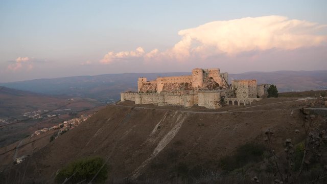Wide angle view of Krak des Chevaliers castle showing its vast size and surrounding Syria landscape