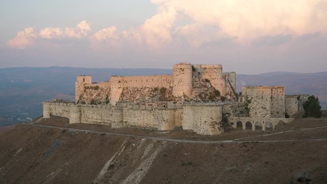 Static shot of the Krak des Chevaliers crusader castle high atop a ridge in Syria