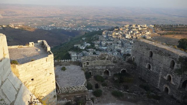 Wide angle view of courtyard and city below the Krak des Chevaliers castle in Syria