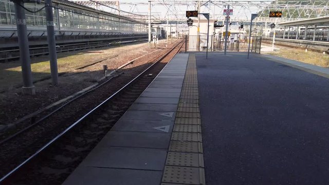 4k Tilt up reveal of empty train platform in Maibara, Japan